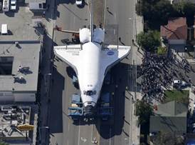 Spectators gather to watch the space shuttle Endeavour make its way down Manchester Blvd. on Friday.